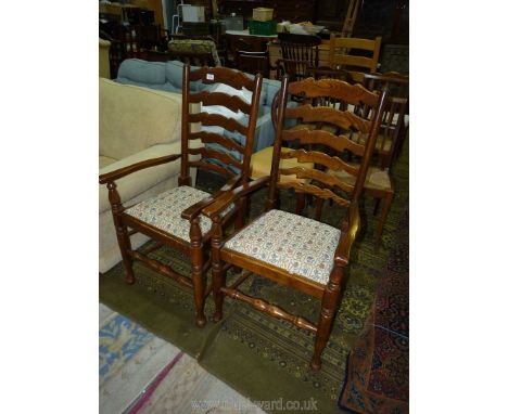 An elegant pair of Oak and other woods ladderback Elbow Chairs on turned legs and with tapestry style upholstered seats.