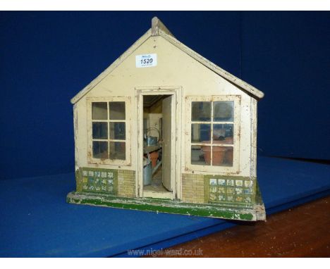 An unusual vintage child's wooden Greenhouse/Doll's House, approximately 1/12 scale painted in crea, with opening door and tw