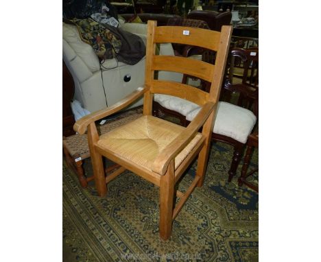 An Ash and other woods woven cane seated ladder back Elbow Chair.