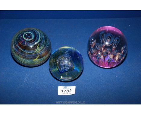 Three paperweights including  large dump shape with air bubbles and gold and purple base, Caithness with air bubble and one w