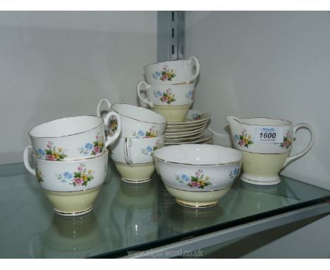 A Consort bone china six setting Teaset in yellow and white with flowers, teapot missing, chip to spout of the milk jug and r