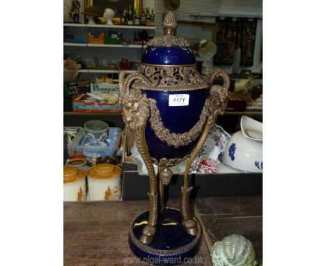 A heavy and imposing deep blue porcelain and ormolu lidded pot pourri Urn having three stylised hoot footed supports, with fo