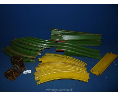 A good quantity of tinplate double lane toy car track, mainly green but some yellow painted and a wind-up clock mechanism dri