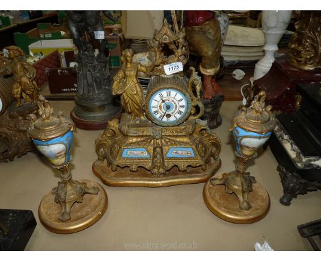 A spelter/ormolu Clock Garniture, the clock having an Alpine style arbour finial (re-attached), the movement having a porcela