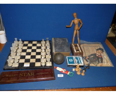 A black and white marble Chess Board, two cribbage boards, secret book money box, metal model station and vintage Charlie Cha