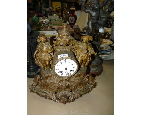 A Spelter Mantel Clock, the frame depicting a Tyrolean scene with a finial depicting a group of conifers. The movement by Jap