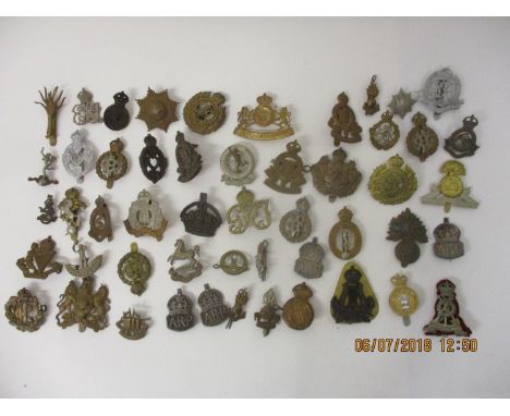 Fifty military badges to include Fusiliers, Royal Army Medical Corps, Royal Canadian Engineers and others 