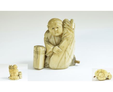 Ivory Netsuke 'Seated Figure', an Oriental man clutching a large sack, with a hexagonal post one side; 1.5 inches high (a/f)