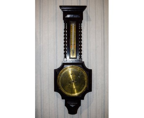 Barometer By Thomas Yates Of Preston Large dark wood mount with brass faced dial and thermometer, turned wood detail to centr