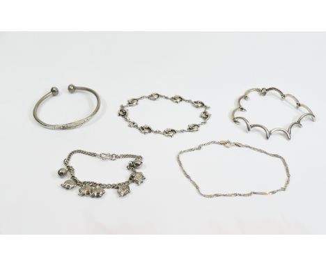 Five Silver Bracelets including child's torque bangle, elephant charm bracelet, dolphin bracelet etc.