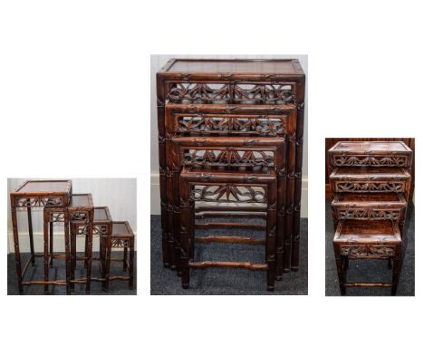 A SET OF CHINESE HONGMU QUARTETTO TABLESEARLY 20TH CENTURY Each with inset panel top and pierced foliate frieze, the legs car