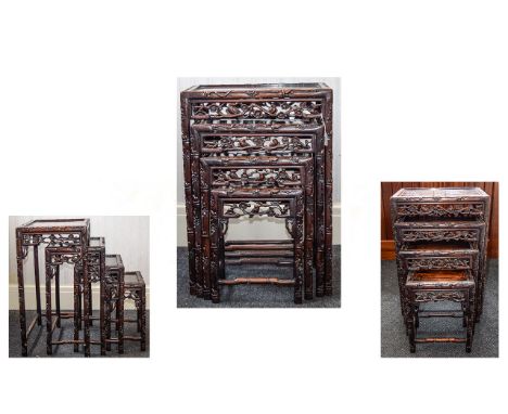 A SET OF CHINESE HONGMU QUARTETTO TABLES19TH CENTURY Each with an inset panel top and pierced frieze carved with birds and fl