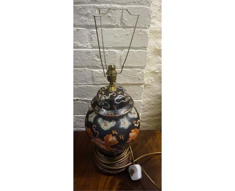 A Chinese Style Ceramic Table Lamp, Decorated with panels of dragons on a black ground, affixed to a hardwood stand, fitted f