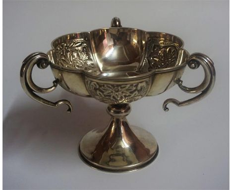 An Edwardian Silver Three Handled Cup, Hallmarks for Birmingham 1905, Decorated with Chinese style embossed floral panels, sc