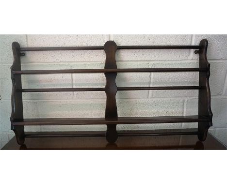 An Ercol Wall Hanging Plate Rack, 62cm high, 105cm wide.