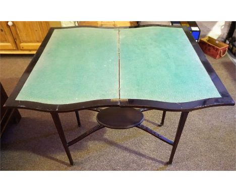 An Edwardian Mahogany Fold Over Card Table, enclosing a green felt lined interior, raised on tapered legs with brass castors 