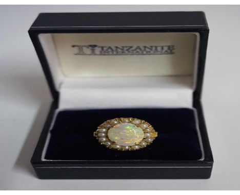 A 9ct Gold Opal & Seed Pearl Dress Ring, the large opal measuring approximately 1cm diameter, overall weight 5.2 grams Condit