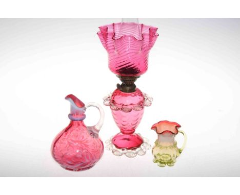Victorian cranberry glass oil lamp, ewer and small jug.