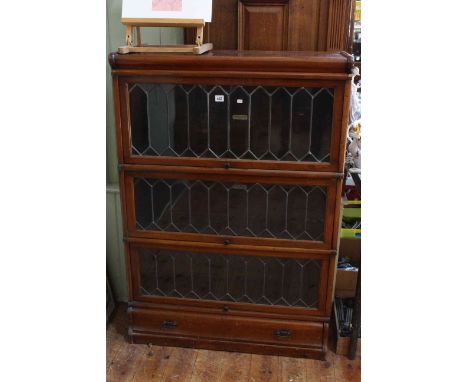 Globe Wernicke mahogany three tier stacking bookcase with leaded glass doors and base drawer, 124cm high by 86cm wide by 30cm