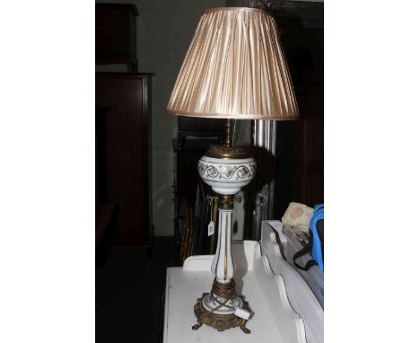 Ornate gilt metal and opaque glass lamp converted to electricity, 92cm high with shade.