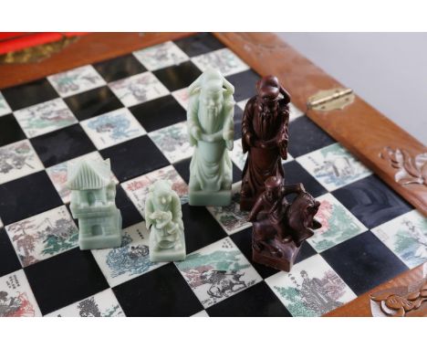 A brass magazine rack with embossed horse and carriage decoration, 12 1/2" high, and a Chinese style chessboard with resin pi