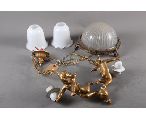 A two-branch ceiling light, formed as two gilt cherubs, with milk glass shades and another ceiling pendant light
