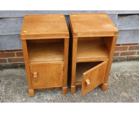 A pair of 1930s light oak bedside cupboards, fitted shelf over one door, on shaped supports, 14" wide x 13" deep x 27" high 