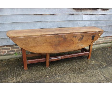 An oak wake table of 17th century design with double gate and moulded supports, 84" long x 48" wide x 29" high 