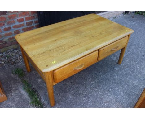 A light oak low coffee table, fitted four shallow drawers, 39" wide x 23" deep x 17" high 