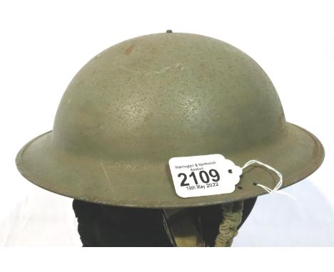 British or Commonwealth WWII helmet with liner and chinstrap. P&amp;P Group 2 (£18+VAT for the first lot and £3+VAT for subse