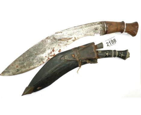 Sheathed kukri with skinning knives and a larger kukri. Larger kukri is 30 cm, has age related marks. P&amp;P Group 3 (£25+VA
