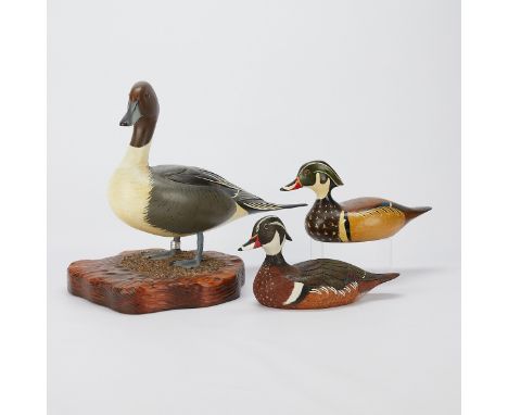 Group of three hand carved and painted wooden duck decoys and models. One wood drake duck marked "Handpainted R. Neegard, Par