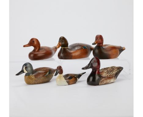 Group of six wooden duck decoys. One with a sticker from The Company Store in Marina Del Ray, California. One from Wildfowler