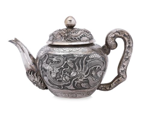A DRAGON AND PHOENIX SILVER TEAPOT
Thailand, 20th century, silver, globular form, with curved handle, exterior decorated with