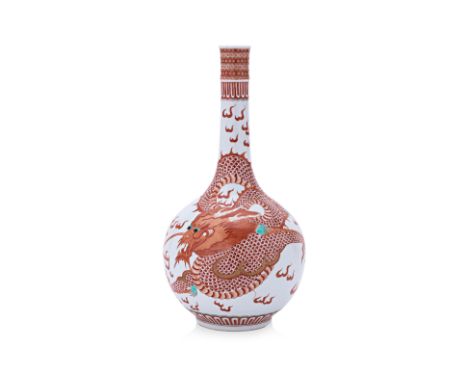 AN IRON RED PORCELAIN BOTTLE VASE Decorated in iron red and gilt with a dragon chasing a pearl, apocryphal Kangxi mark to bas