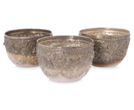 A SET OF THREE BURMESE SILVER BOWLS
Circa 20th century, silver, each with five panels with repousse animals on foliate ground