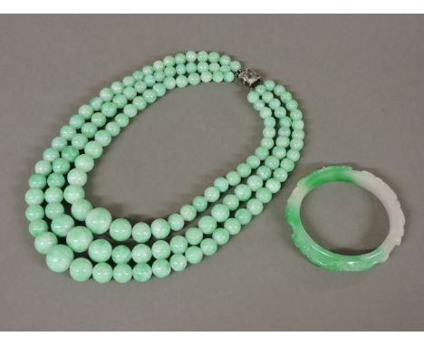 A three row Peking glass bead necklace, and a hardstone bangle