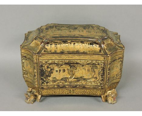 A Chinese lacquered and gilt tea caddy, on cast iron legs, the interior with two lidded compartments, 21.5cm wide