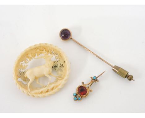 A gold metal red paste stone and blue paste comet brooch, a gold amethyst cabochon stick pin marked 333, and a 19th century c