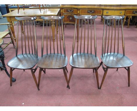 A Set of Four Ercol Dark Stained Dining Chairs, with a shaped top rail, rail supports, circular legs, united by H stretchers.