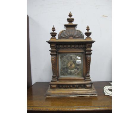 A Late XIX Century Walnut Mantel Clock, with turned finial's, arched top, square dial, Roman numerals, on stepped base, 60cm 