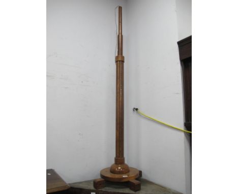 a 1920's Walnut Art Deco Standard Lamp, with a moulded pedestal circular base, on four block supports.