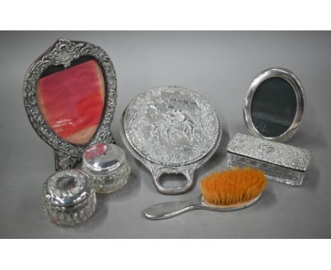 A late Victorian silver hand-mirror, London 1899, to/w a heart-shaped easel photograph frame, Birmingham 1901, a small oval f