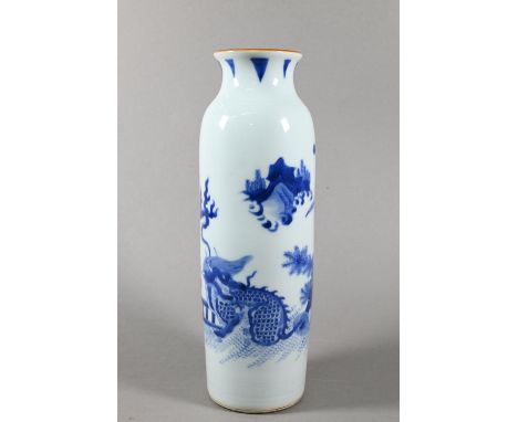 A Chinese Transitional style blue and white sleeve vase, painted in rich tones of underglaze blue with a continuous garden la