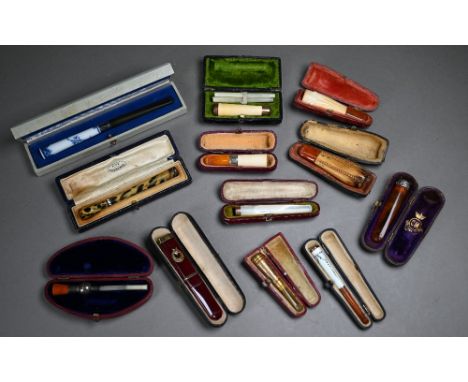 A selection of twelve cased cheroot/cigarette-holders, variously in amber, meerschaum, silver, enamel and base metal&nbsp; 