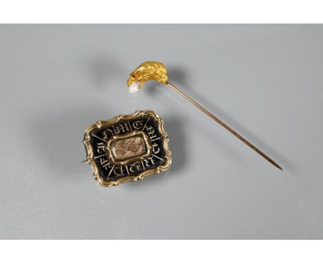 An early Victorian rectangular mourning brooch, the black enamel with inscription around a hairwork centrepiece, gold set, 2.