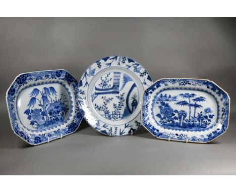Two 18th century Chinese octagonal tureen stands painted in underglaze blue with pine tree and willow tree landscapes within 
