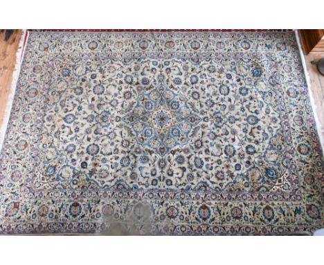 A contemporary central Persian Kashan carpet, the pale jade and camel ground with stylised floral design, 365 cm x 260 cm 