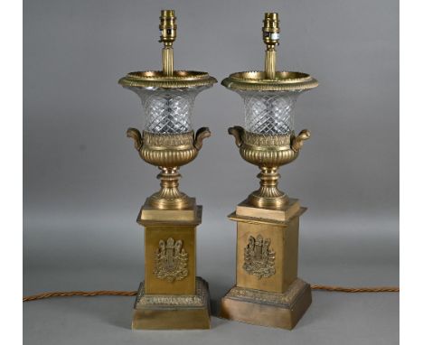 A pair of gilt metal mounted cut glass table lamps, with applied lyre tablets by Tindle Lighting, London c/with cream shades,