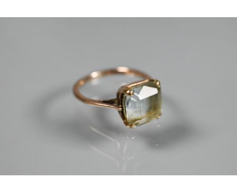 A square pale aquamarine set unmarked yellow metal, size K, 0.6 x 0.6 cm 